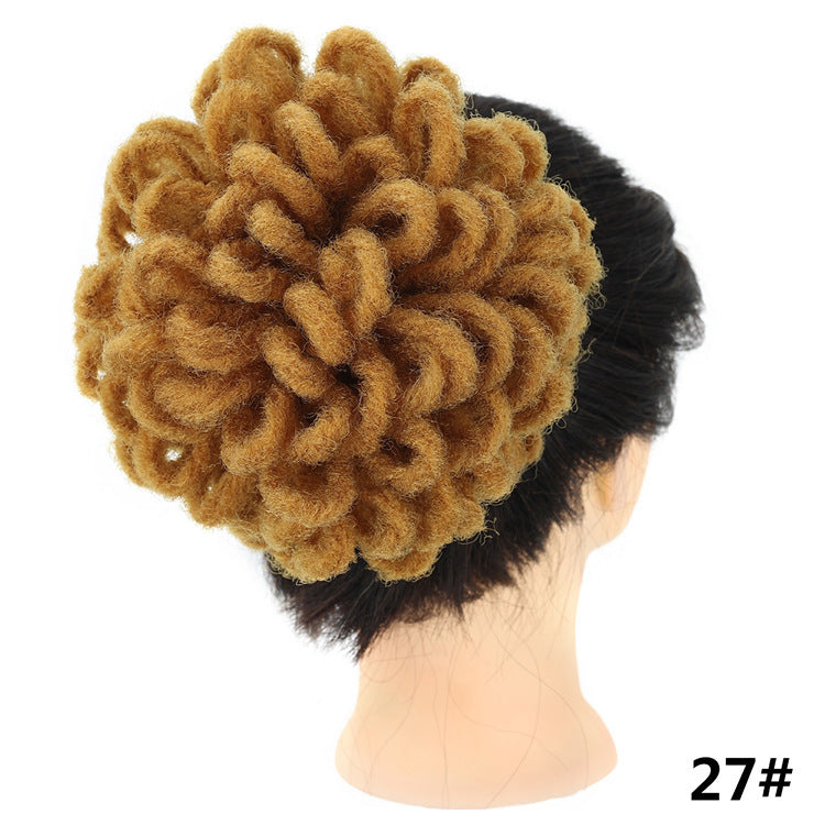 Brown textured hair bun accessory on a mannequin head with a white background