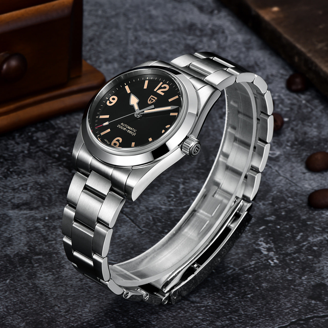 Silver wristwatch with black dial on a dark textured surface