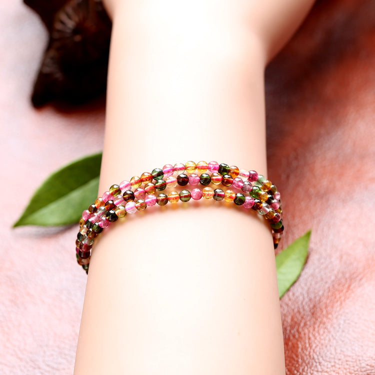 Multicolored beaded bracelet on a wrist with a blurred background