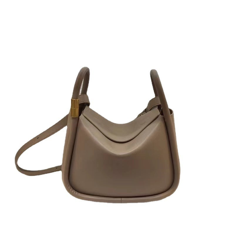 Beige handbag with a strap on a white background