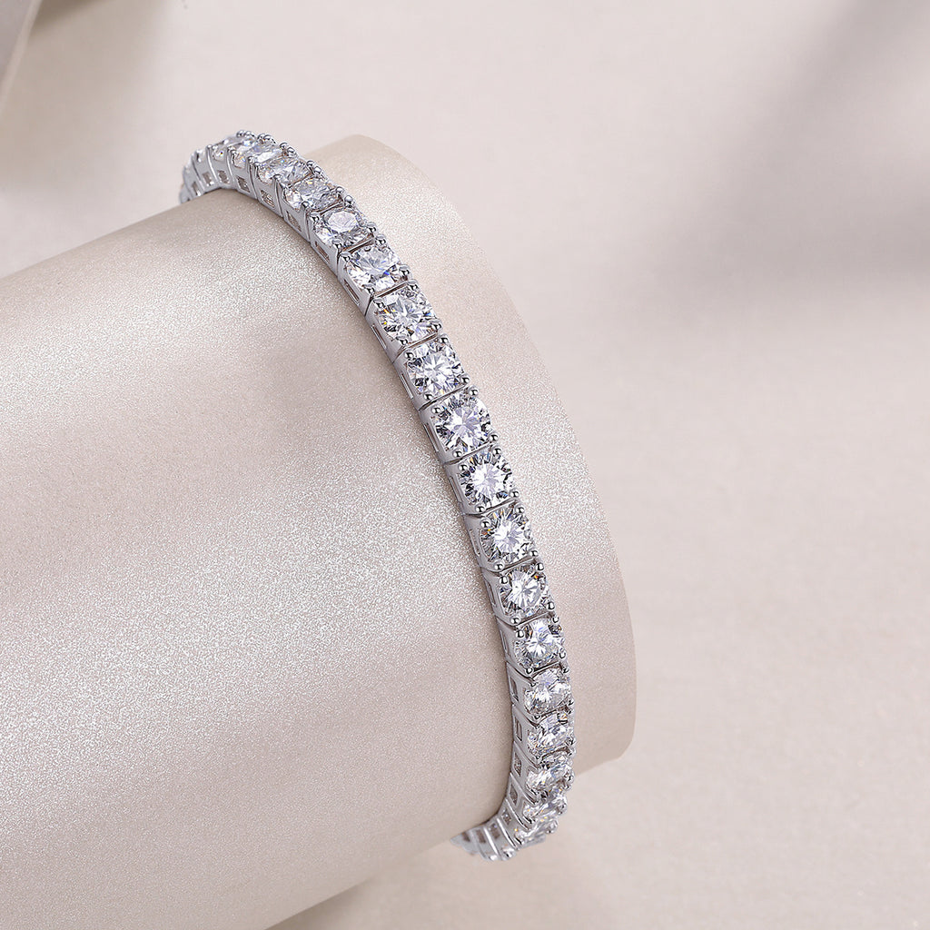 Diamond bracelet on a mannequin arm with a plain background