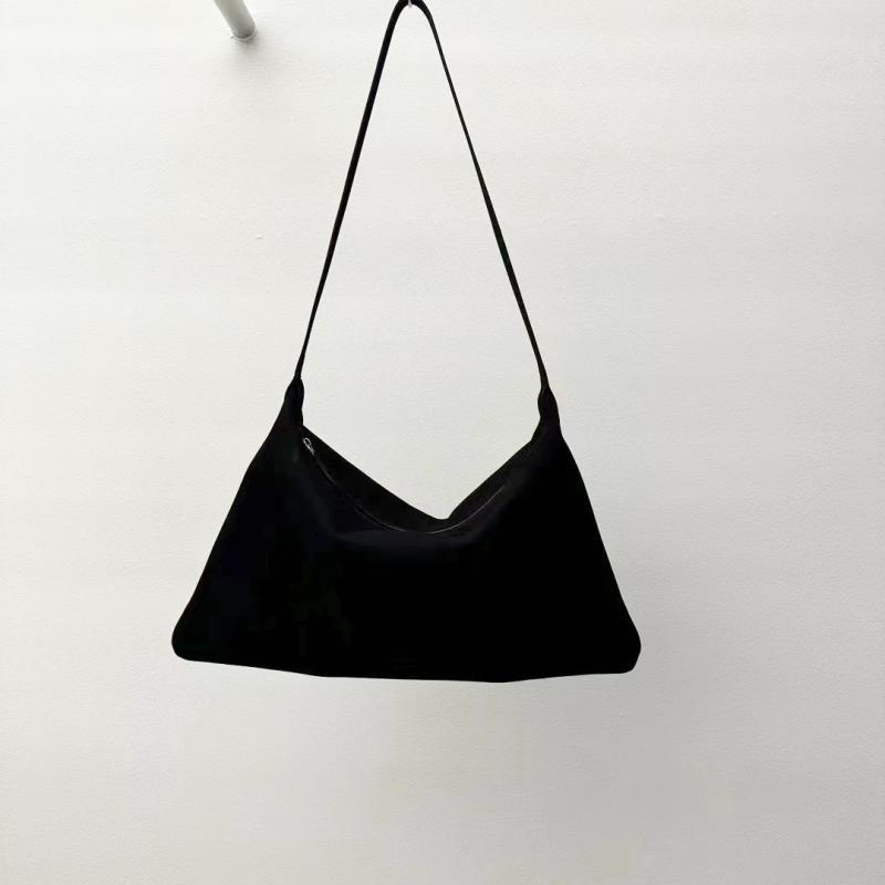 Black shoulder bag hanging against a white background