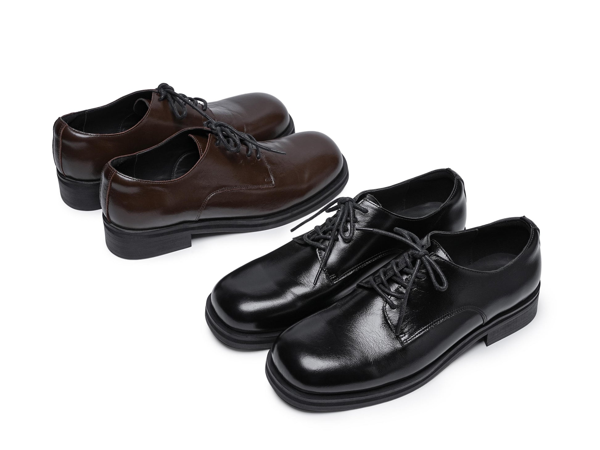 Pair of brown leather shoes and a pair of black leather shoes on a white background