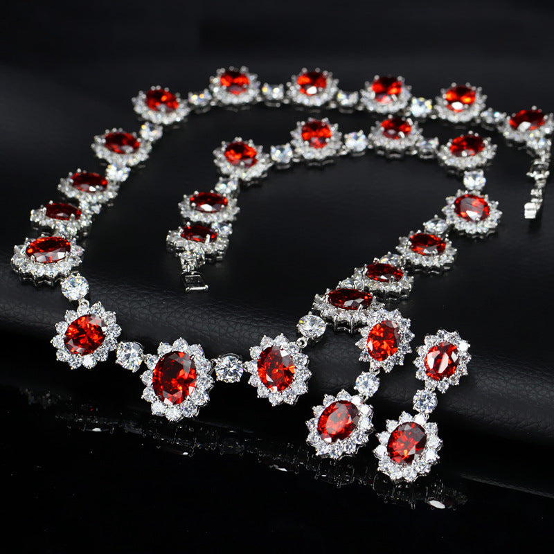 Necklace with red gemstones and clear stones on a dark background