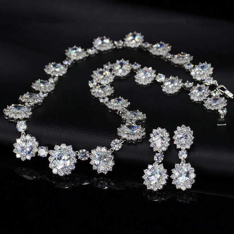 Silver jewelry set with necklace and earrings on a black background