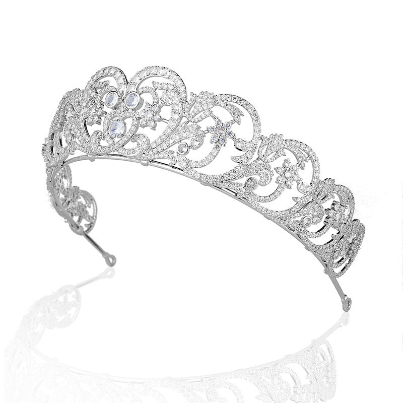 Silver tiara with intricate design on a white background