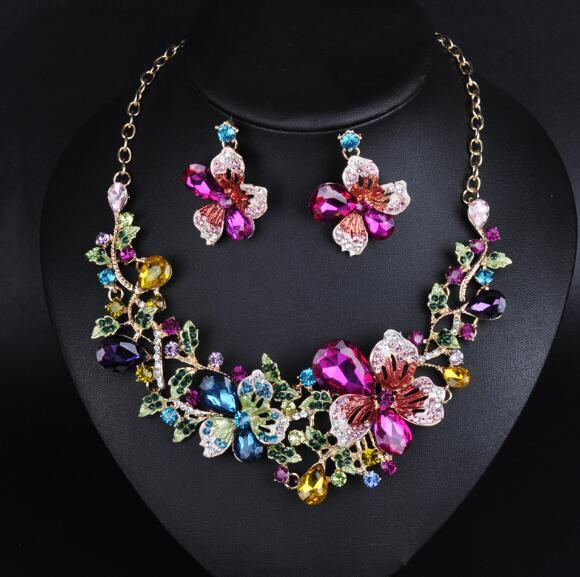 Colorful jewelry set with necklace and earrings on a black heart-shaped background