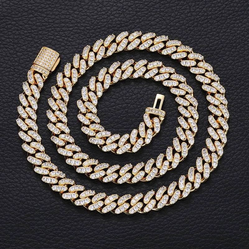Gold chain necklace with diamond-like stones on a black textured background