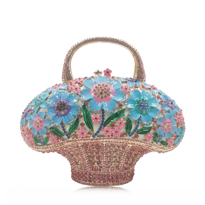 Decorative handbag with floral design and beaded details on a white background