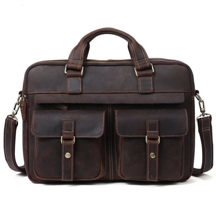 Brown leather briefcase with multiple pockets and straps on a white background