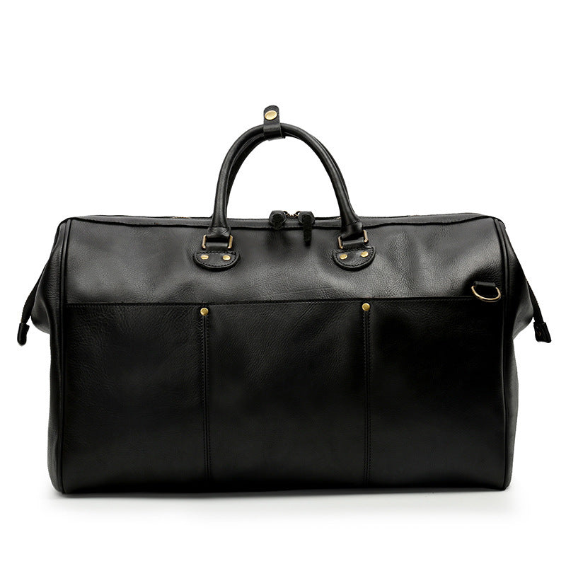 Black leather duffel bag with gold hardware on a white background