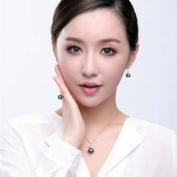 Woman wearing earrings and a necklace on a white background