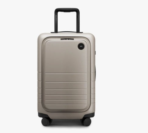 Beige suitcase with a black handle on a white background