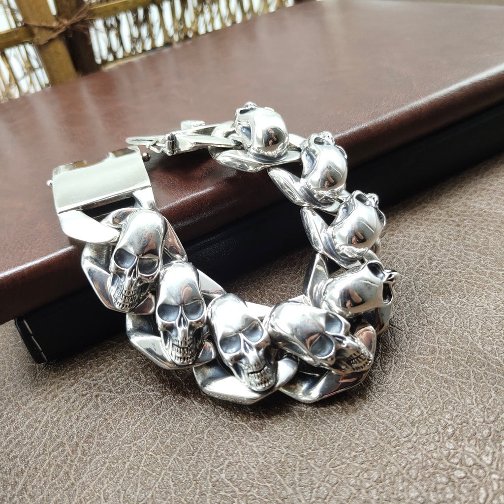 Silver skull bracelet on a textured surface