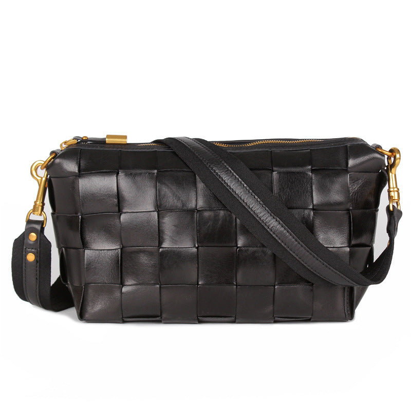 Black woven handbag with gold accents on a white background