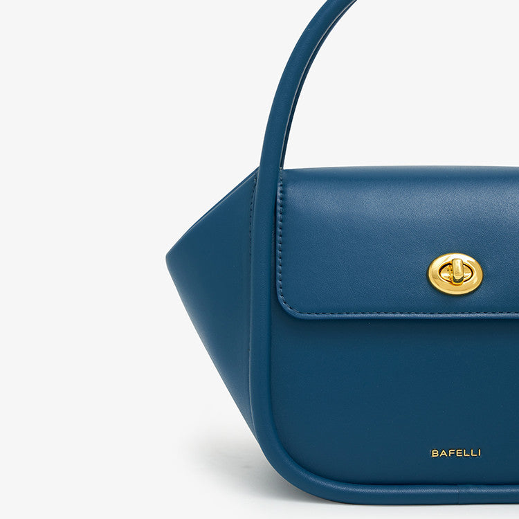 Blue handbag with a gold clasp on a light gray background