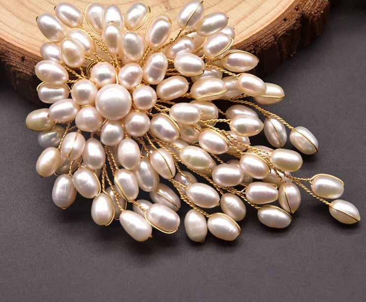 Pearl brooch with gold accents on a wooden surface