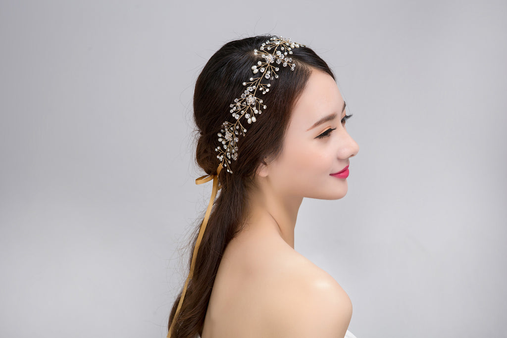 Woman wearing a decorative headband with a plain background