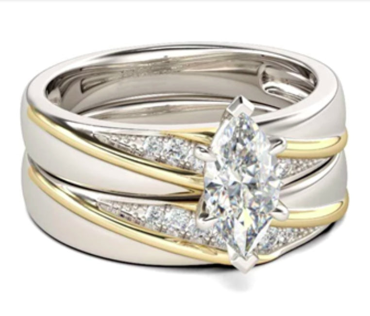 Two diamond rings, one gold and one silver, on a white background