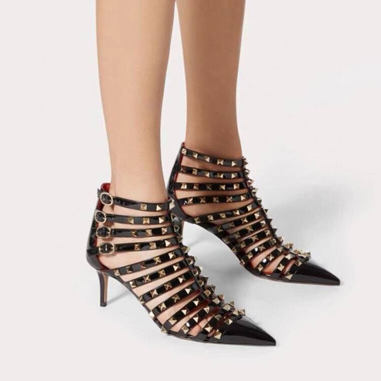 Black studded high-heeled shoes on a white background
