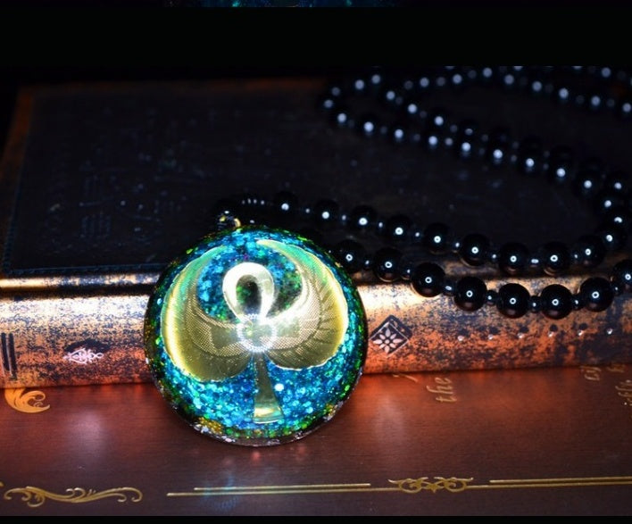 Necklace with a round pendant featuring a symbol on an old book