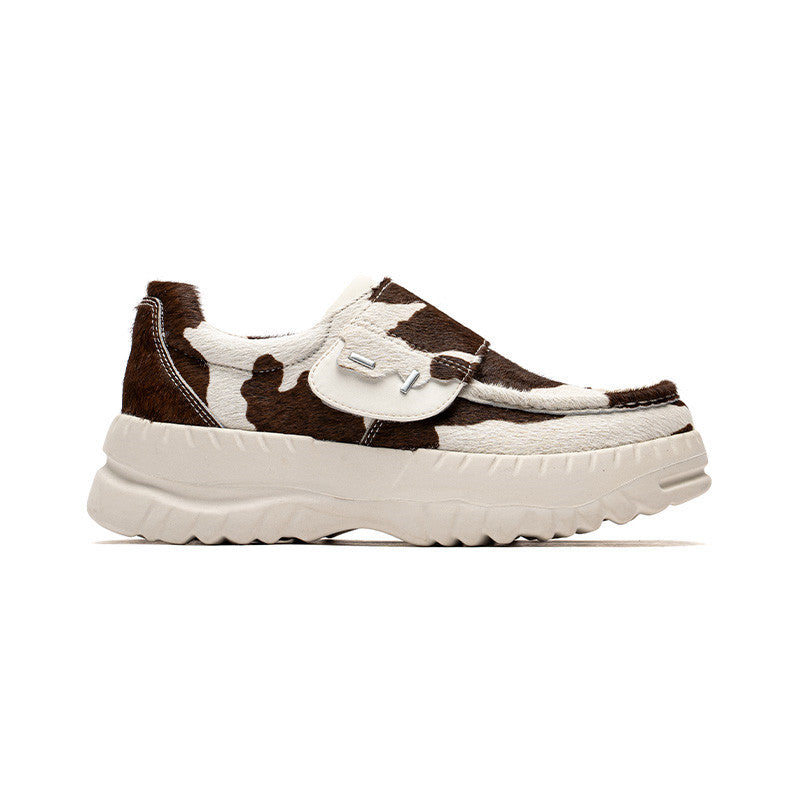 Brown and white sneaker with a thick sole on a white background