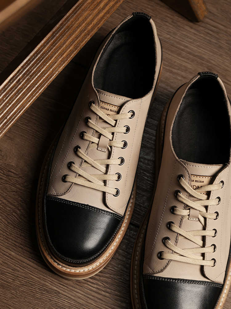 Pair of brown and black sneakers on a wooden surface