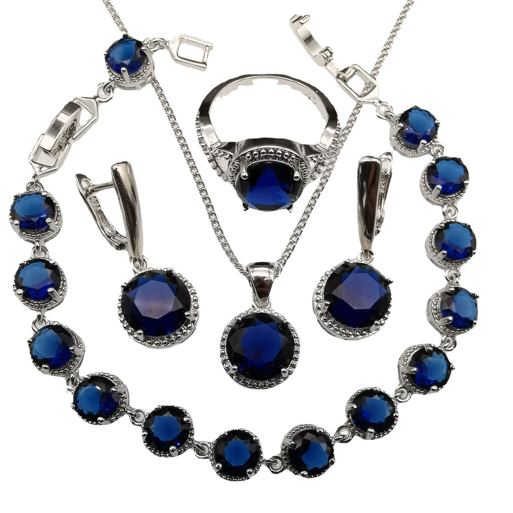 Jewelry set with blue gemstones and silver accents on a white background