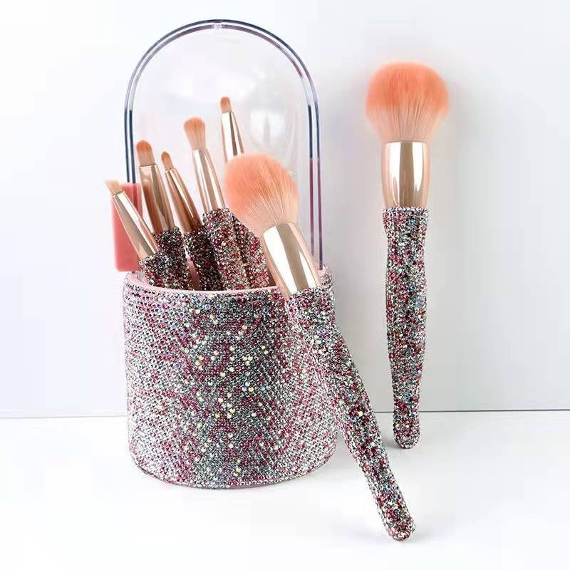 Makeup brushes with glittery holder on a white background