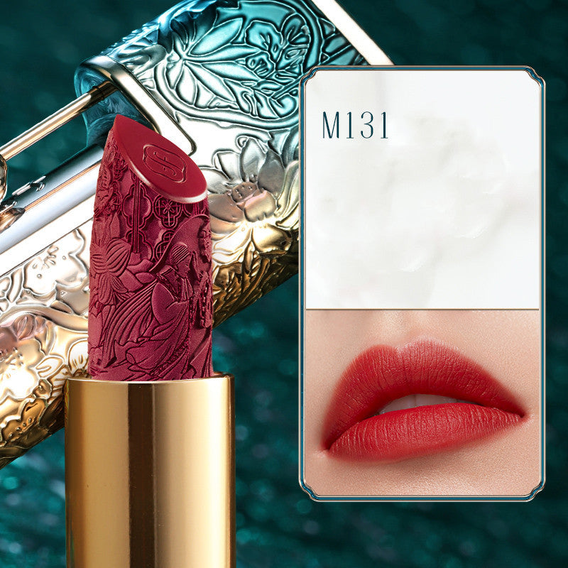 Red lipstick with decorative case and color swatch on a teal background