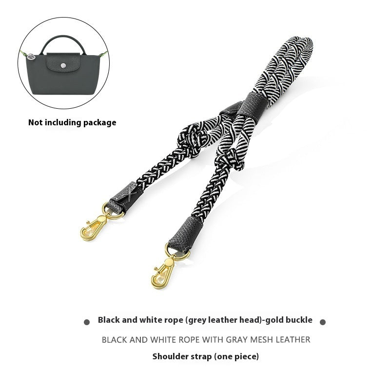 Black and white rope shoulder strap with gold buckle on a white background