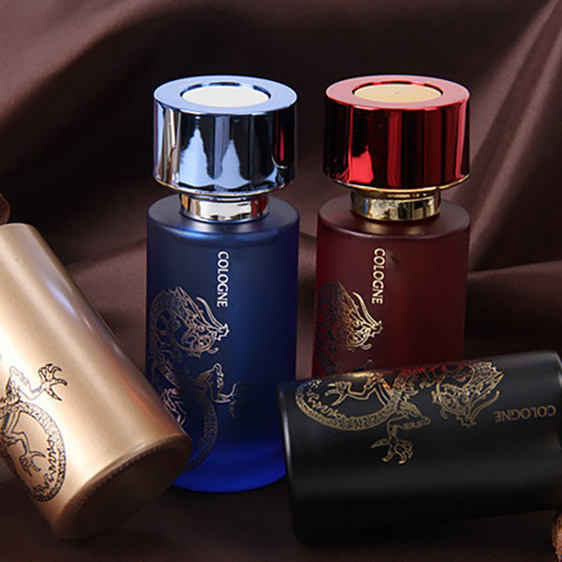 Four cologne bottles with different colored caps on a dark background
