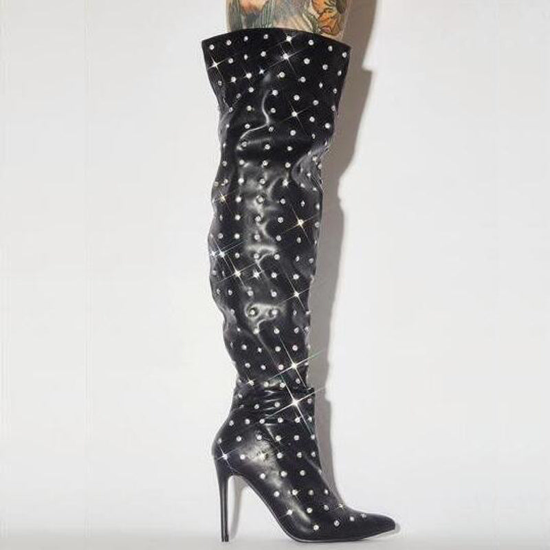 Black knee-high boot with rhinestone details on a white background