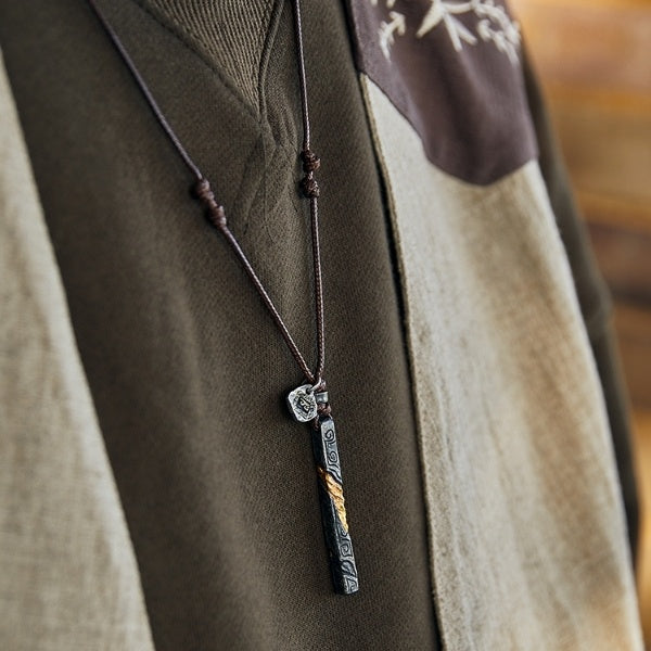 Necklace with a pendant on a fabric background