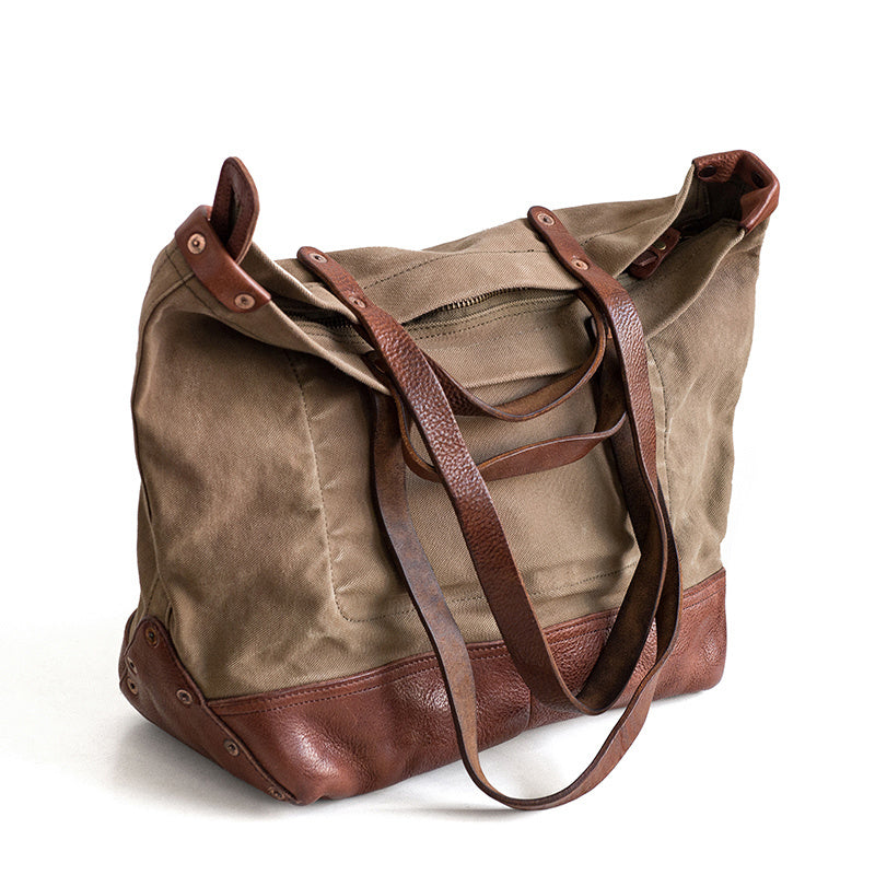 Brown leather and canvas bag on a white background