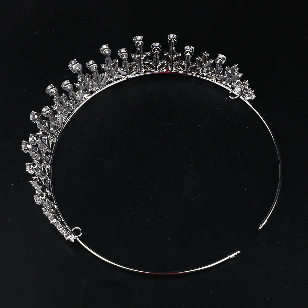 Silver tiara with clear stones on a black background