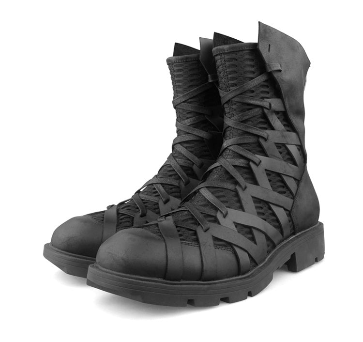 Black lace-up boots on a white background