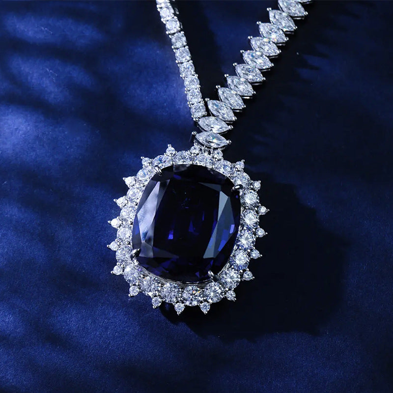 Luxury diamond necklace with a large blue gemstone on a dark blue background