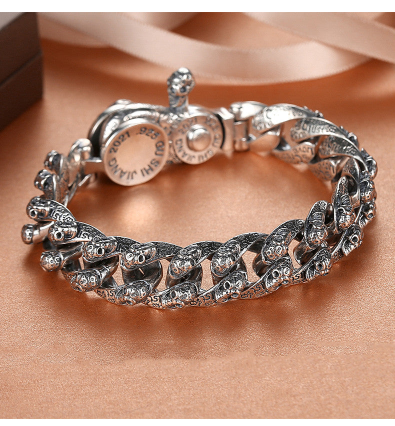 Silver chain bracelet on a soft pink background