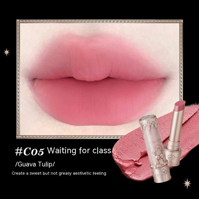 Close-up of pink lips with two lipsticks on a black background