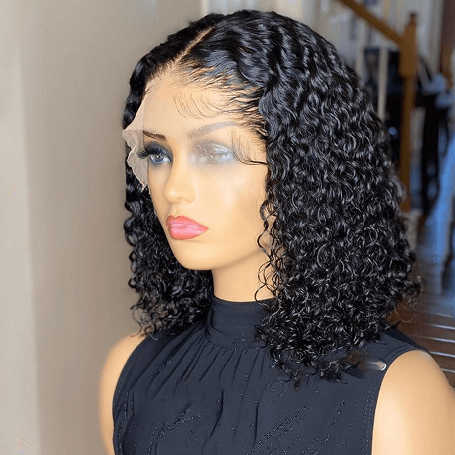 Mannequin head with a black curly wig on a neutral background