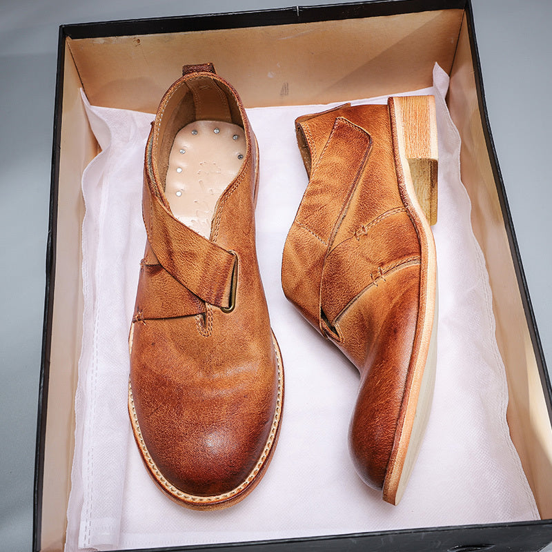 Pair of brown leather shoes in a box on a gray background