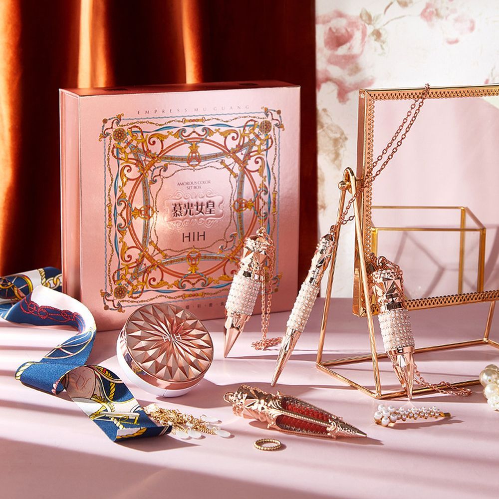 Luxury jewelry set with decorative box on a pink surface