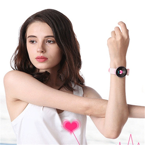 Woman wearing a smartwatch with a heart rate monitor on a white background