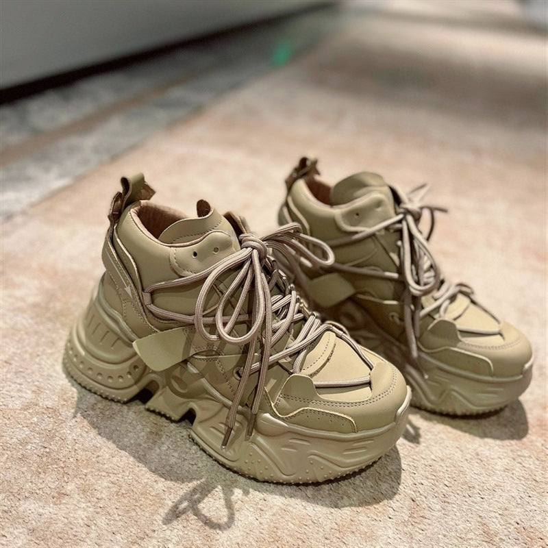 Pair of beige sneakers on a textured surface