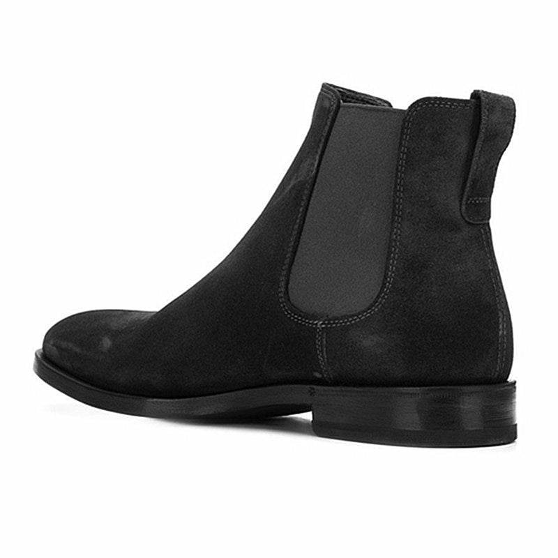 Black Chelsea boot on a white background