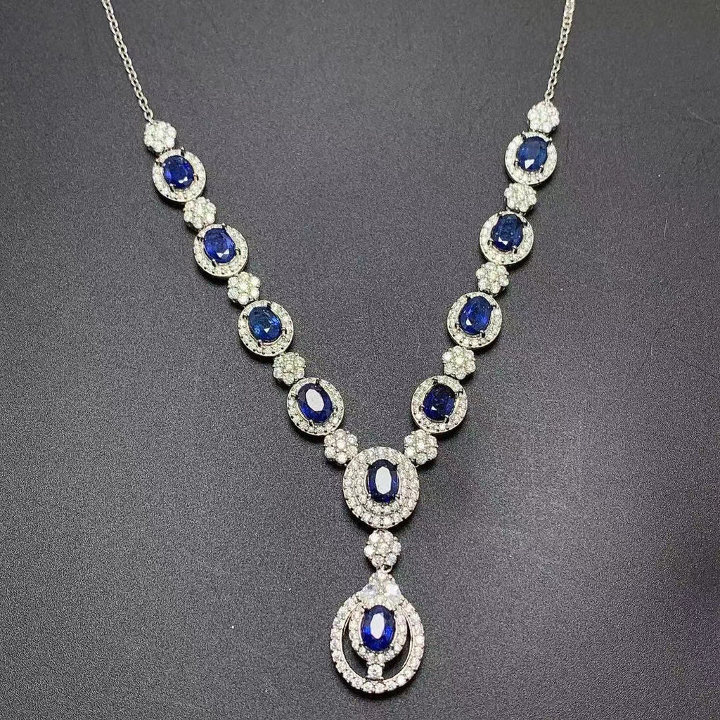 Elegant necklace with blue gemstones and diamonds on a dark background