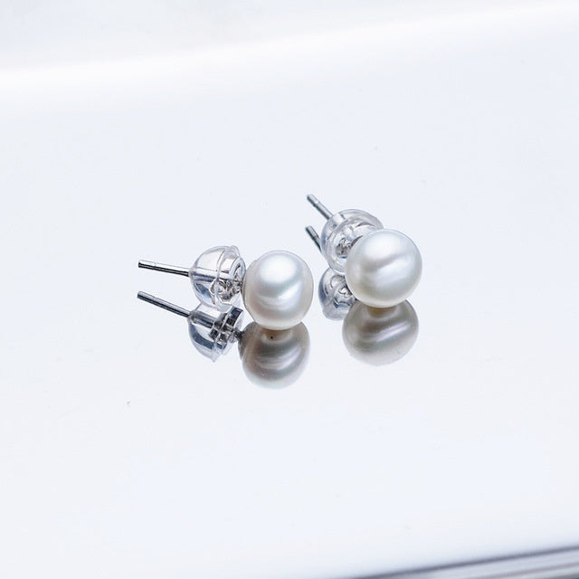 Pearl earrings on a light gray background