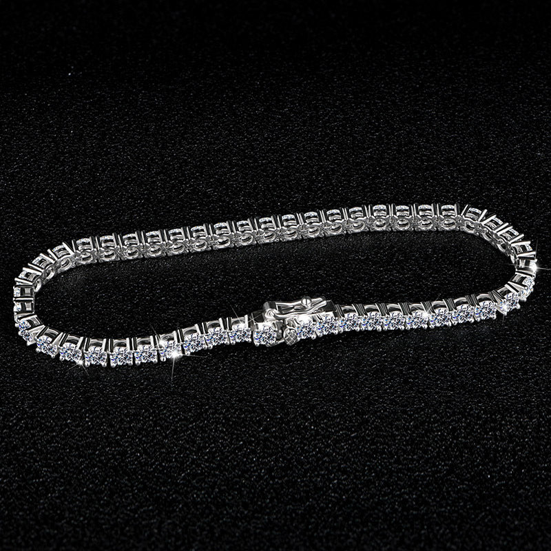 Silver bracelet with clear stones on a black background