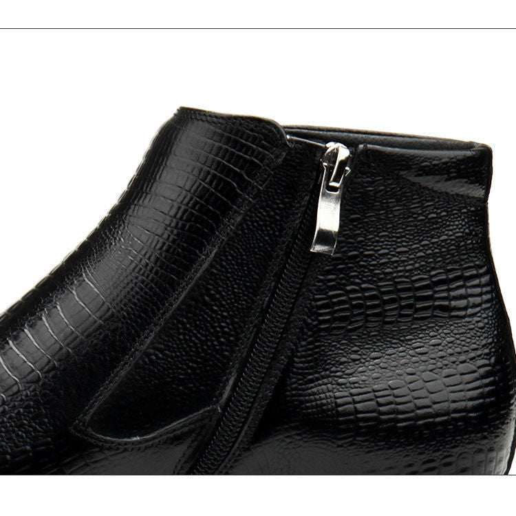 Black crocodile-patterned clutch bag with a silver zipper on a white background